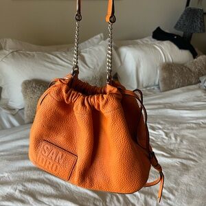 Orange Sandro Paris grained leather bucket bag
